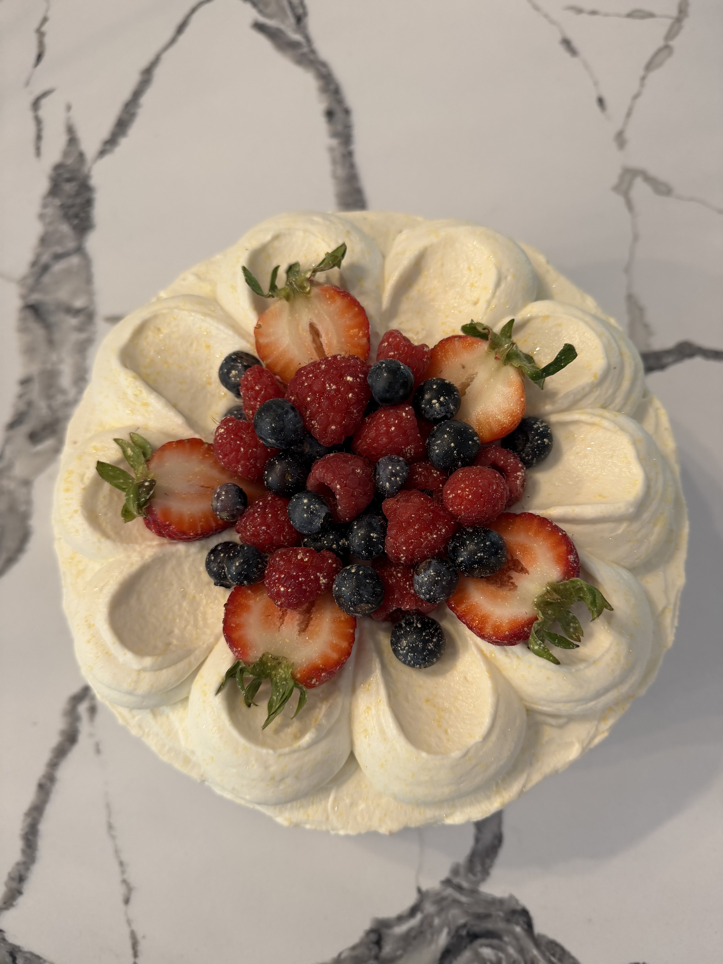 Mixed berry Chantilly cake topped with fresh berries
